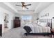 Main bedroom with large windows, ceiling fan, and ensuite bathroom at 944 Black Saddle St, Elizabeth, CO 80107