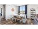 Casual dining area with a white table, bench, and hardwood floors at 944 Black Saddle St, Elizabeth, CO 80107