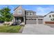 Two-story home with gray siding, stone accents, and a two-car garage at 944 Black Saddle St, Elizabeth, CO 80107