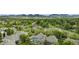 Aerial view of the neighborhood with mature trees and mountain views at 11862 W Stanford Pl, Morrison, CO 80465