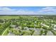 Aerial view of the neighborhood showcasing mature trees, a lake, and mountain views at 11862 W Stanford Pl, Morrison, CO 80465