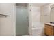 Bright bathroom featuring a glass shower, soaking tub, and vanity with sink at 11862 W Stanford Pl, Morrison, CO 80465