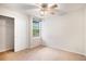 Bedroom with neutral carpet, window, ceiling fan and closet with sliding doors at 11862 W Stanford Pl, Morrison, CO 80465