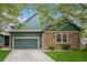Charming two-story home with a blend of stone and blue siding, plus an attached two-car garage and well-maintained lawn at 11862 W Stanford Pl, Morrison, CO 80465