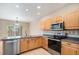 Cozy kitchen featuring stainless steel appliances, a corner sink, and ample cabinetry with backyard views at 11862 W Stanford Pl, Morrison, CO 80465