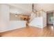 Open concept living room with hardwood floors, staircase and kitchen view, perfect for Gathering gatherings and entertaining at 11862 W Stanford Pl, Morrison, CO 80465