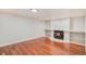 Finished living room with hardwood floors and a fireplace with built-in shelving at 11862 W Stanford Pl, Morrison, CO 80465