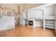 Bright living room with hardwood floors, fireplace, and built-in shelving offering a cozy and inviting atmosphere at 11862 W Stanford Pl, Morrison, CO 80465