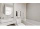 Bright bathroom featuring a shower-tub combo, toilet, and vanity at 314 Galapago St, Denver, CO 80223