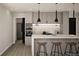 Bright, modern kitchen with barstool seating, sleek countertops, and pendant lighting at 314 Galapago St, Denver, CO 80223