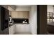 Stylish kitchen with contrasting black and white cabinetry, wooden accents, and hardwood floors at 314 Galapago St, Denver, CO 80223