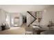 Inviting living room features a staircase, hardwood flooring, and a sitting area, all bathed in natural light at 314 Galapago St, Denver, CO 80223