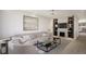 Inviting living room with built-in shelving, fireplace, modern decor, and hardwood floors at 314 Galapago St, Denver, CO 80223