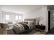 Bright main bedroom with a large bed, windows, balcony, and seating area at 314 Galapago St, Denver, CO 80223