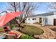 Serene backyard with a patio area, mature trees, and lush landscaping at 3256 S Glencoe St, Denver, CO 80222