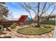Cozy backyard with a seating area, mature trees, and landscaped garden beds at 3256 S Glencoe St, Denver, CO 80222