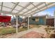 Inviting backyard featuring a covered patio, mature trees, and a charming storage shed at 3256 S Glencoe St, Denver, CO 80222