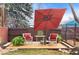 Outdoor patio setting with cozy chairs and an umbrella offers a relaxing outdoor living space at 3256 S Glencoe St, Denver, CO 80222