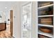 Clean, well-lit bathroom with walk-in shower, modern fixtures, and built-in shelving at 3256 S Glencoe St, Denver, CO 80222