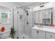 Modern bathroom featuring a glass-enclosed shower, mosaic accents, and stylish vanity at 3256 S Glencoe St, Denver, CO 80222