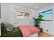 Bright bedroom with a large window, hardwood floors, and a cozy bed at 3256 S Glencoe St, Denver, CO 80222
