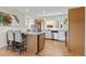 Renovated kitchen with an island, seating, and stainless steel appliances at 3256 S Glencoe St, Denver, CO 80222