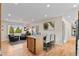 Spacious kitchen area with an island, bar stools, and hardwood flooring at 3256 S Glencoe St, Denver, CO 80222
