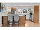 Updated kitchen featuring stainless appliances, countertop seating, and hardwood floors at 3256 S Glencoe St, Denver, CO 80222