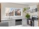 Updated kitchen with white cabinets, granite countertops, and stainless steel appliances at 3256 S Glencoe St, Denver, CO 80222