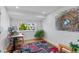 Bright office space with hardwood floors, a large window, and colorful artwork on the wall at 3256 S Glencoe St, Denver, CO 80222