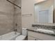 Well-lit bathroom featuring a shower-tub combo, a granite countertop vanity, and a neutral color scheme at 875 E 78Th Ave # 72, Denver, CO 80229