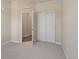 Bedroom with carpeted flooring, sliding closet doors and view into the entryway at 875 E 78Th Ave # 72, Denver, CO 80229