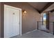 Apartment entrance featuring a white door with the number 72 and a modern lantern at 875 E 78Th Ave # 72, Denver, CO 80229