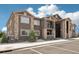 Exterior view of the apartment complex, showcasing the stone and stucco design with parking in view at 875 E 78Th Ave # 72, Denver, CO 80229