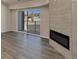 Bright living room featuring modern fireplace, wood-look flooring, and balcony access at 875 E 78Th Ave # 72, Denver, CO 80229