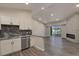 Open living space with granite counters in kitchen, fireplace and sliding glass doors to balcony at 875 E 78Th Ave # 72, Denver, CO 80229