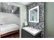 Contemporary bathroom features a stone accent wall, sleek vanity, and access to the bedroom at 2100 16Th St # 600, Denver, CO 80202