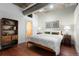 Cozy bedroom featuring hardwood floors, soft lighting, industrial ceiling, and stylish furnishings at 2100 16Th St # 600, Denver, CO 80202