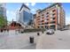 Exterior featuring a contemporary building, pedestrian bridge and nearby shops with outside patio dining at 2100 16Th St # 600, Denver, CO 80202