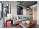 Living room features a painting of an elephant, large windows, and a concrete ceiling at 2100 16Th St # 600, Denver, CO 80202