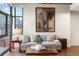 Living room features a painting of an elephant, large windows, and a concrete ceiling at 2100 16Th St # 600, Denver, CO 80202