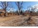 Large backyard featuring mature trees, wood fence, and a gravel area to enjoy the outdoors at 1698 S Kingston St, Aurora, CO 80012
