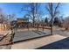 Backyard with a wooden deck and concrete patio, surrounded by mature trees and a wooden fence at 1698 S Kingston St, Aurora, CO 80012