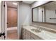 A full bathroom offers marble countertops, a large mirror and a door open to the bath tub with tile surround at 1698 S Kingston St, Aurora, CO 80012