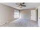 This neutral bedroom offers carpet flooring and lots of natural light from the large windows and a ceiling fan at 1698 S Kingston St, Aurora, CO 80012