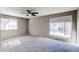 This neutral bedroom offers carpet flooring, a ceiling fan and lots of natural light from the large windows at 1698 S Kingston St, Aurora, CO 80012