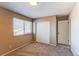 Neutral carpeted bedroom with ample natural light, closet, and door to hall at 1698 S Kingston St, Aurora, CO 80012