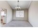 A dining room offers carpet flooring and a chandelier with great natural light and an open concept at 1698 S Kingston St, Aurora, CO 80012