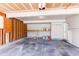 Spacious two-car garage with ample storage space, workbench, and overhead lighting at 1698 S Kingston St, Aurora, CO 80012