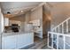 Open concept kitchen with white cabinets, a peninsula, and views to the stairs and living room at 1698 S Kingston St, Aurora, CO 80012